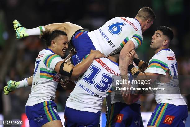 Jamal Fogarty of the Raiders celebrates with team mates after scoring a try during the round 14 NRL match between Wests Tigers and Canberra Raiders...