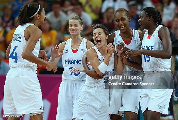 France captain Celine Dumerc celebrates with team mates after winning the Women's Basketball Preliminary Round match between Australia and France on...