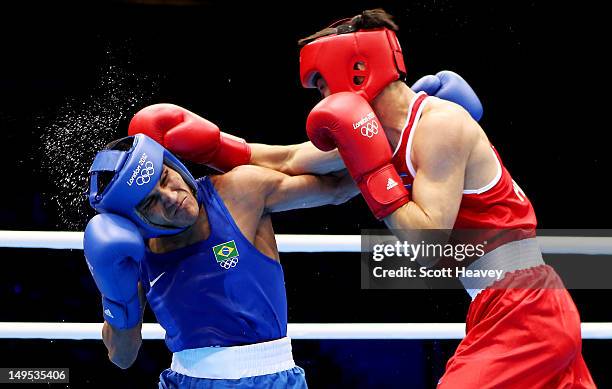 Juliao Henriques Neto of Brazil in action with Jong Chol Pak of North Korea during their Men's Fly Boxing on Day 3 of the London 2012 Olympic Games...