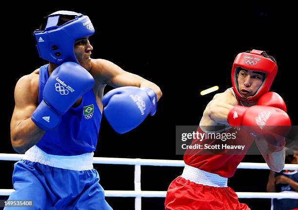 Juliao Henriques Neto of Brazil in action with Jong Chol Pak of North Korea during their Men's Fly Boxing on Day 3 of the London 2012 Olympic Games...
