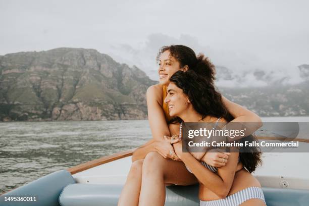 two woman embrace during a romantic boat ride - propose stock pictures, royalty-free photos & images