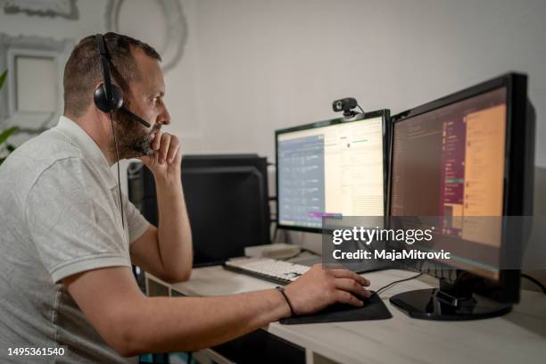 young smiling man in headphones typing on laptop keyboard - italy migrants stock pictures, royalty-free photos & images