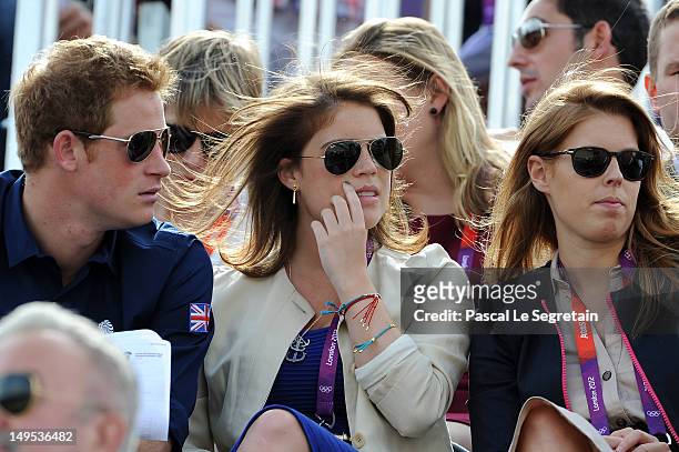 Prince Harry, Princess Eugenie, and Princess Beatrice watch the Eventing Cross Country Equestrian event on Day 3 of the London 2012 Olympic Games at...