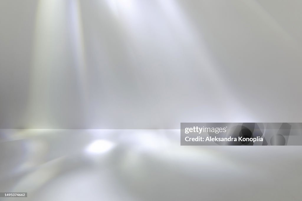 Modern Studio Backdrop - abstract empty stage with dreamy crystal reflections on neutral gray background. Surreal caustic disco light effect