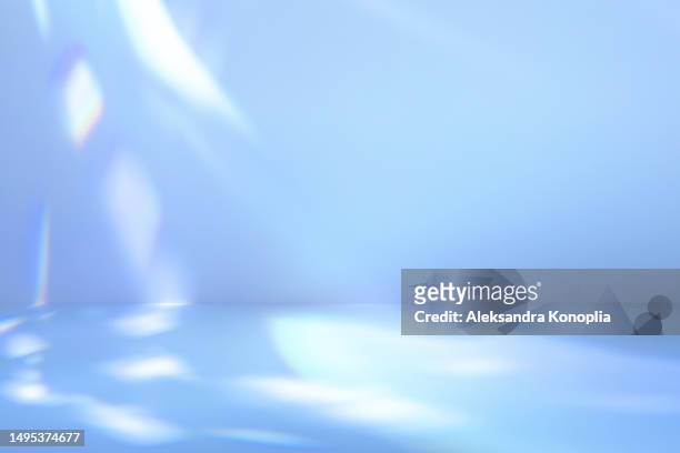 empty pastel blue colored scene - abstract studio room, stage background with crystal rainbow light refraction, disco ball light effects, front view, copy space - rainbow light reflection stock pictures, royalty-free photos & images