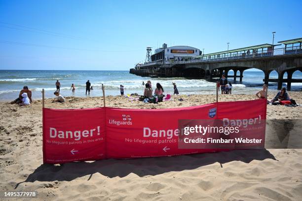 Danger sign warning of no lifeguards in the area is seen at Bournemouth Pier, following the deaths of two children at Bournemouth beach on 31st May,...