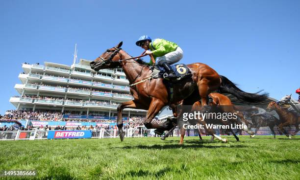 Austrian Theory ridden by Joe Fanning wins the Racehorse Lotto Handicap Stakes during Ladies Day of the Derby Festival at Epsom Downs Racecourse on...