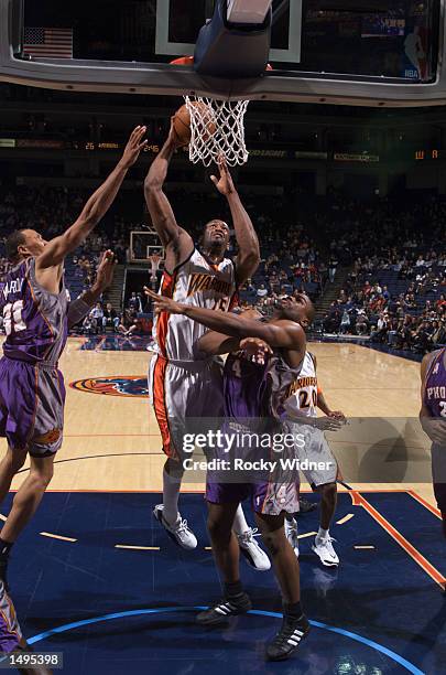 Erick Dampier of the Golden State Warriors shoots over Alton Ford of the Phoenix Suns at The Arena in Oakland, California. DIGITAL IMAGE. NOTE TO...