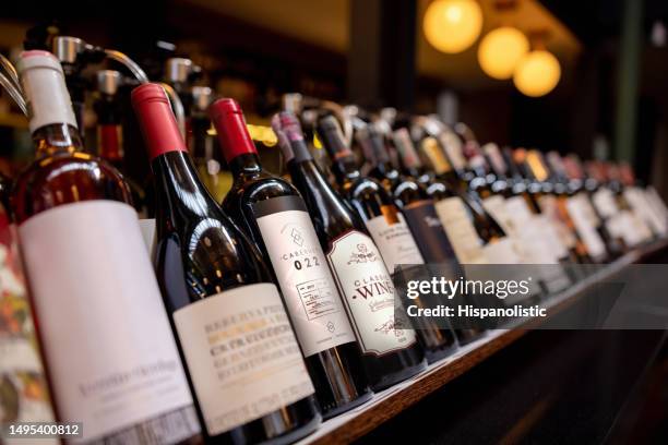 close-up on bottles of wine displayed at a winery - off licence stock pictures, royalty-free photos & images