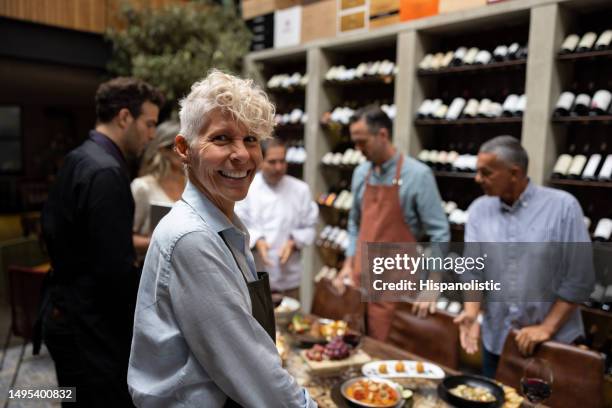 happy waitress smiling in a staff meeting at a restaurant - agricultural cooperative stockfoto's en -beelden