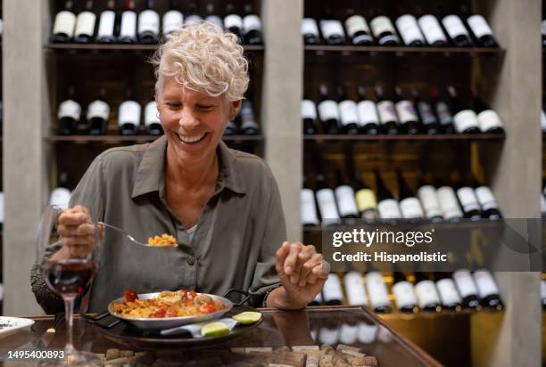 happy woman having dinner at a restaurant and smiling - spanish food stock pictures, royalty-free photos & images
