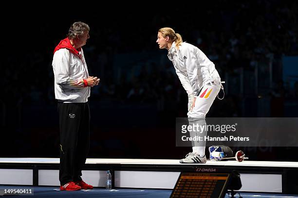 Britta Heidemann of Germany argues with her coach Manfred Kaspar after an issue with an expired clock was addressed in her bout against A Lam Shin of...