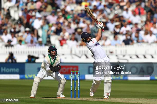 Ollie Pope of England hits a straight six to reach his double centur as Ireland wicketkeeper Lorcan Tucker looks on during day two of the LV=...