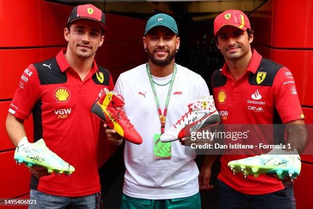 Neymar meets Charles Leclerc of Monaco and Ferrari and Carlos Sainz of Spain and Ferrari in the paddock during previews ahead of the F1 Grand Prix of...