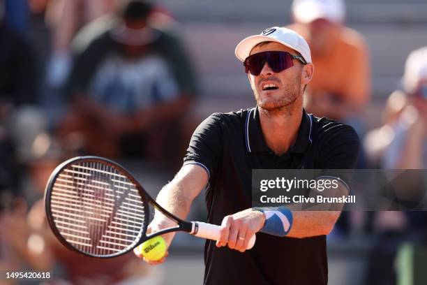 Jamie Murray of Great Britain serves alongside partner Taylor Townsend of United States against Desirae Krawczyk of United States and Joe Salisbury...