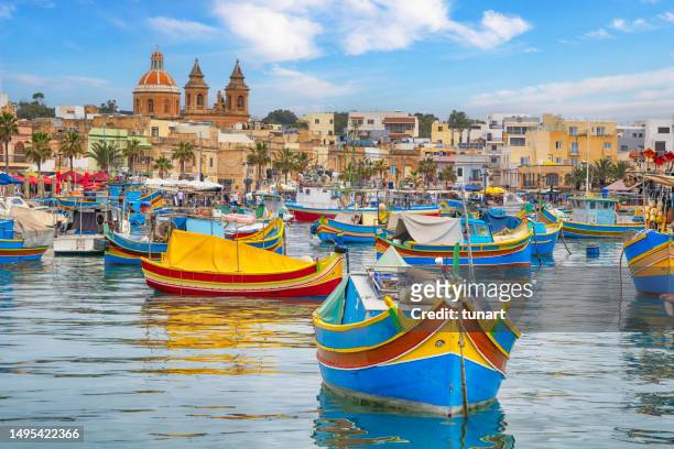 colorful traditional fishing boats in marsaxlokk village - maltese islands stockfoto's en -beelden