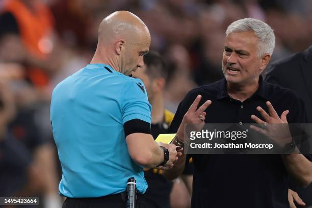 Jose Mourinho Head coach of AS Roma discusses with the Referee Anthony Taylor of England during the UEFA Europa League 2022/23 final match between...