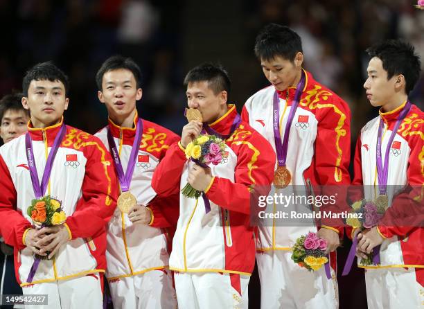 Gold medalists Zhe Feng, Weiyang Guo, Yibing Chen, Chenglong Zhang and Kai Zou of China celebrate on the podium during the medal ceremony in the...