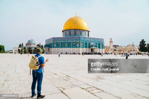 asian man praying with dome of rock at the background - palestinian clothes stock pictures, royalty-free photos & images