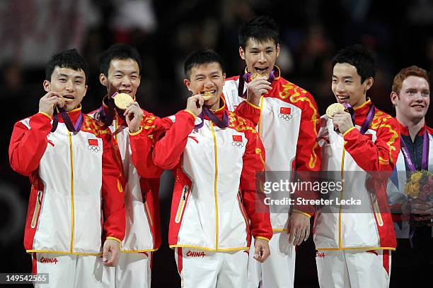 Gold medalists Zhe Feng, Weiyang Guo, Yibing Chen, Chenglong Zhang and Kai Zou of China celebrate on the podium during the medal ceremony in the...