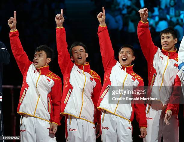 Gold medalists Zhe Feng, Weiyang Guo, Yibing Chen, Chenglong Zhang and Kai Zou of China celebrate on the podium during the medal ceremony in the...