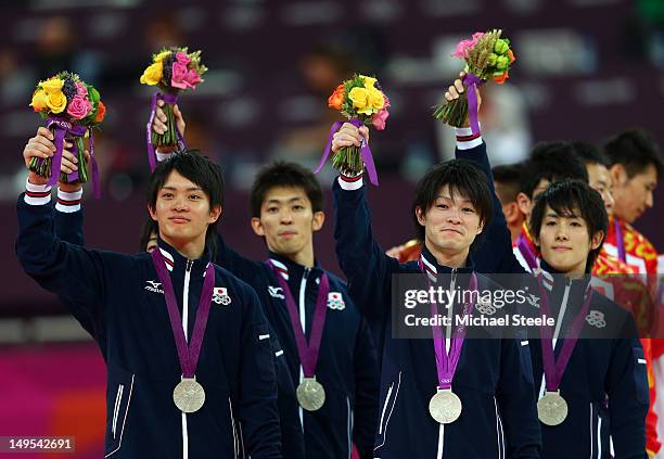 Silver medalists Kohei Uchimura, Yusuke Tanaka, Koji Yamamuro, Kazuhito Tanaka and Ryohei Kato of Japan celebrate during the medal ceremony in the...