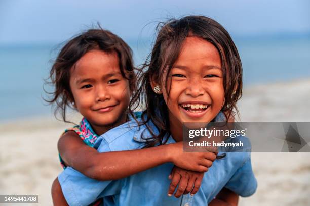 cambodian little girls playing on the beach, cambodia - cambodian ethnicity stock pictures, royalty-free photos & images