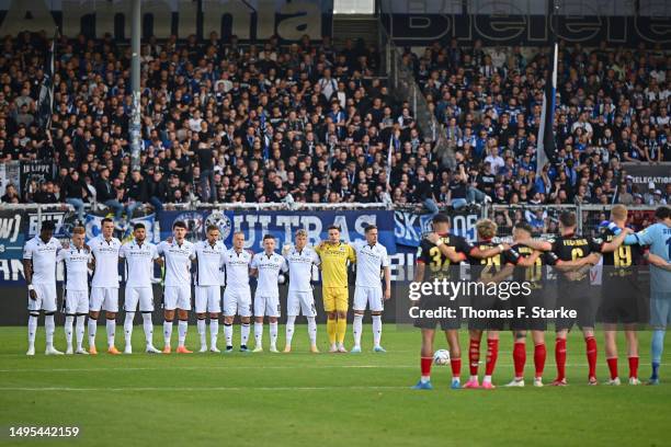 Both teams hold a minute of silence prior to the Second Bundesliga playoffs first leg match between SV Wehen Wiesbaden and DSC Arminia Bielefeld at...