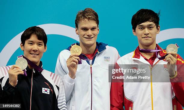 First Silver medalist Sun Yang of China, gold medalist Yannick Agnel of France and second silver medalist Tae-Hwan Park of Korea pose for a photo...