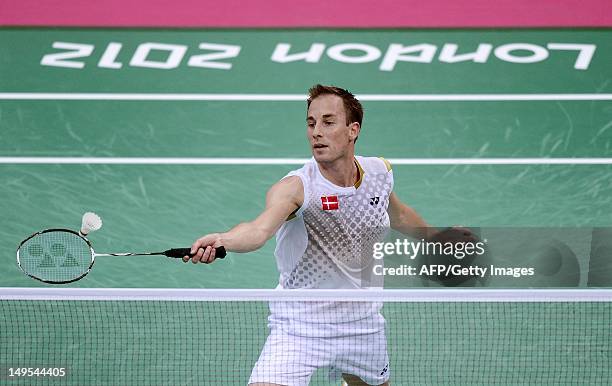 Denmark's Peter Gade returns a shot to Pedro Martins of Portugal during their men's singles badminton match at the London 2012 Olympic Games in...