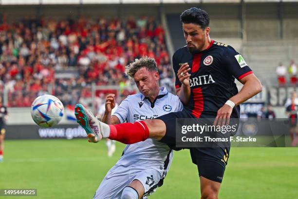 Ahmet Guerleyen of Wiesbaden tackles Robin Hack of Bielefeld during the Second Bundesliga playoffs first leg match between SV Wehen Wiesbaden and DSC...