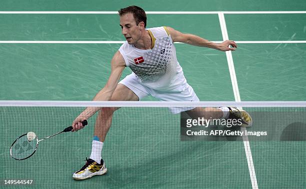 Denmark's Peter Gade returns a shot to Pedro Martins of Portugal during their men's singles badminton match at the London 2012 Olympic Games in...