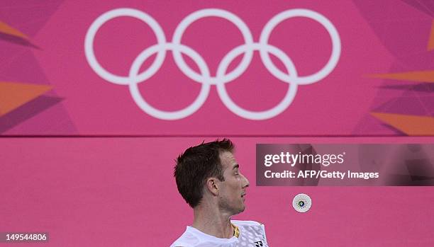 Denmark's Peter Gade watches the shuttlecock as he returns a shot to Pedro Martins of Portugal during their men's single badminton match at the...