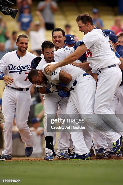 Matt Kemp of the Los Angeles Dodgers celebrates with teammates James Loney, Andre Ethier, Luis Cruz and winning pitcher Jamey Wright after he hit a...