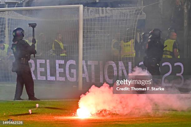 Riot police stand in front the away sector of Bielefeld supporters1 during the Second Bundesliga playoffs first leg match between SV Wehen Wiesbaden...