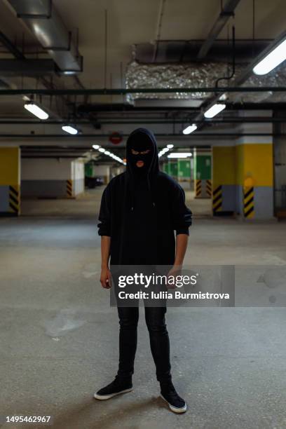 tall young man wearing face mask standing in empty parking garage - stranger stock pictures, royalty-free photos & images