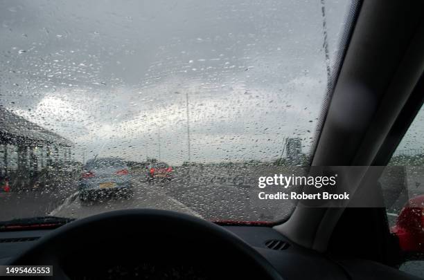 close-up of car windscreen with view obscured by rain. - car interior no people stock pictures, royalty-free photos & images