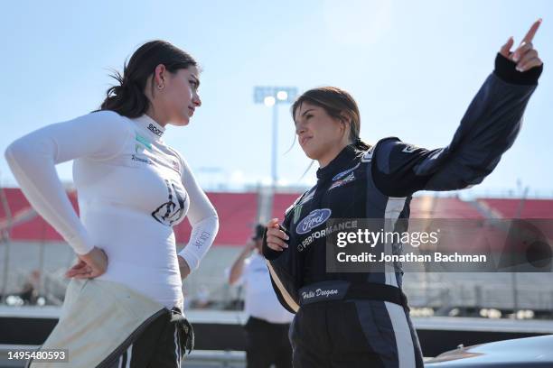 Toni Breidinger, driver of the HomeSmiles Toyota, and Hailie Deegan, driver of the Ford Performance Ford, talk on the grid during practice for the...