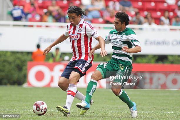 Hector Reynoso of Chivas and Herculez Gomez of Santos fight for the ball during a match between Chivas and Santos as part of the Liga MX 2012 at...
