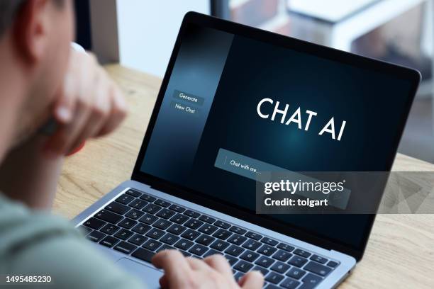 man using laptop with artificial intelligence screen - fake advertisement stock pictures, royalty-free photos & images