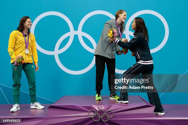 Silver medalist Emily Seebohm of Australia, gold medalist Missy Franklin of the UNited States and bronze medalist Aya Terakawa of Japan celebrate on...