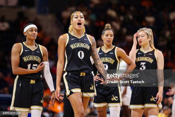 Shakira Austin of the Washington Mystics reacts as teammates look on during the first half of the game against the Dallas Wings at Entertainment &...