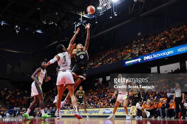 Shakira Austin of the Washington Mystics drives to the basket against Satou Sabally of the Dallas Wings during the first half of the game at...