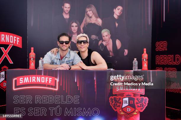 Christopher Uckermann and Christian Chávez of group RBD pose for a photo during an event to sign autographs to Vodka Smirnoff bottles at Walmart...