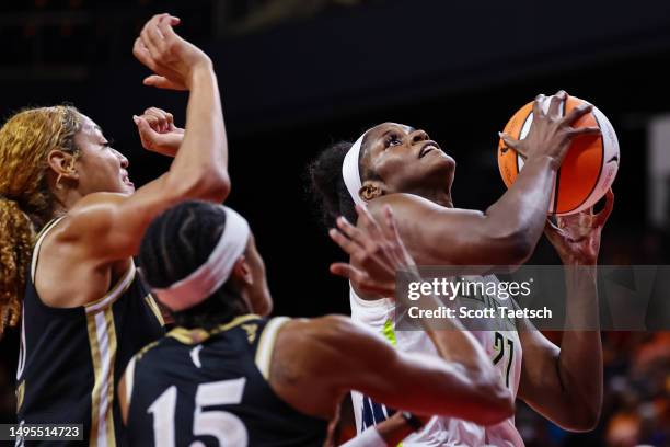 Kalani Brown of the Dallas Wings goes to the basket against Shakira Austin and Brittney Sykes of the Washington Mystics during the second half of the...