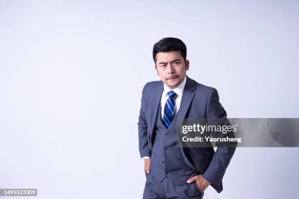 portrait of a confident  asian successful businessman against white background - pudong stock pictures, royalty-free photos & images