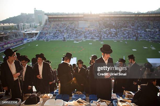 Men pray as tens of thousands of Ultra Orthodox Jews attend Siyum HaShas, a celebration marking completion of a seven-and a half year daily...