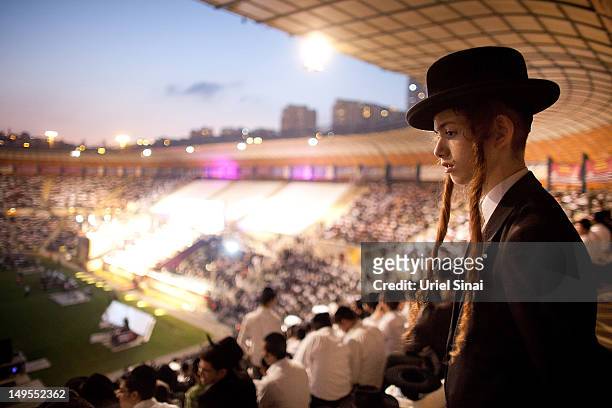 Boy looks on as tens of thousands of Ultra Orthodox Jews attend Siyum HaShas, a celebration marking completion of a seven-and a half year daily...