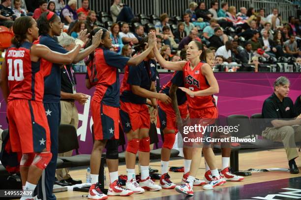 Sue Bird of the United States high fives her teammates against Angola at the Olympic Park Basketball Arena during the London Olympic Games on July...