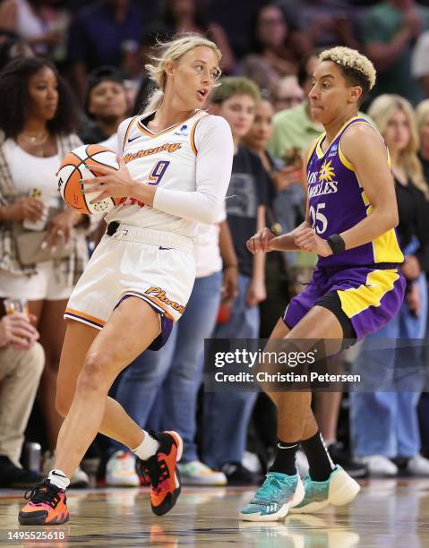 Sophie Cunningham of the Phoenix Mercury handles the ball against Layshia Clarendon of the Los Angeles Sparks during the first half of WNBA game at...